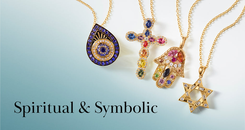 Four gold necklaces with pendants: an evil eye, a jeweled cross, a jeweled Hamsa hand, and a Star of David, displayed on a light blue and white background with the text Spiritual & Symbolic.
