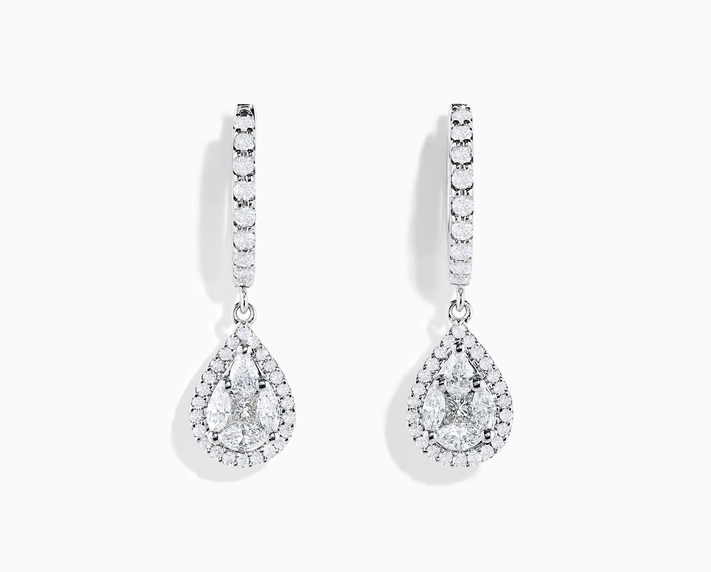 A pair of elegant drop earrings featuring teardrop-shaped diamonds surrounded by smaller diamonds, with diamond-studded hoops, set against a plain white background.