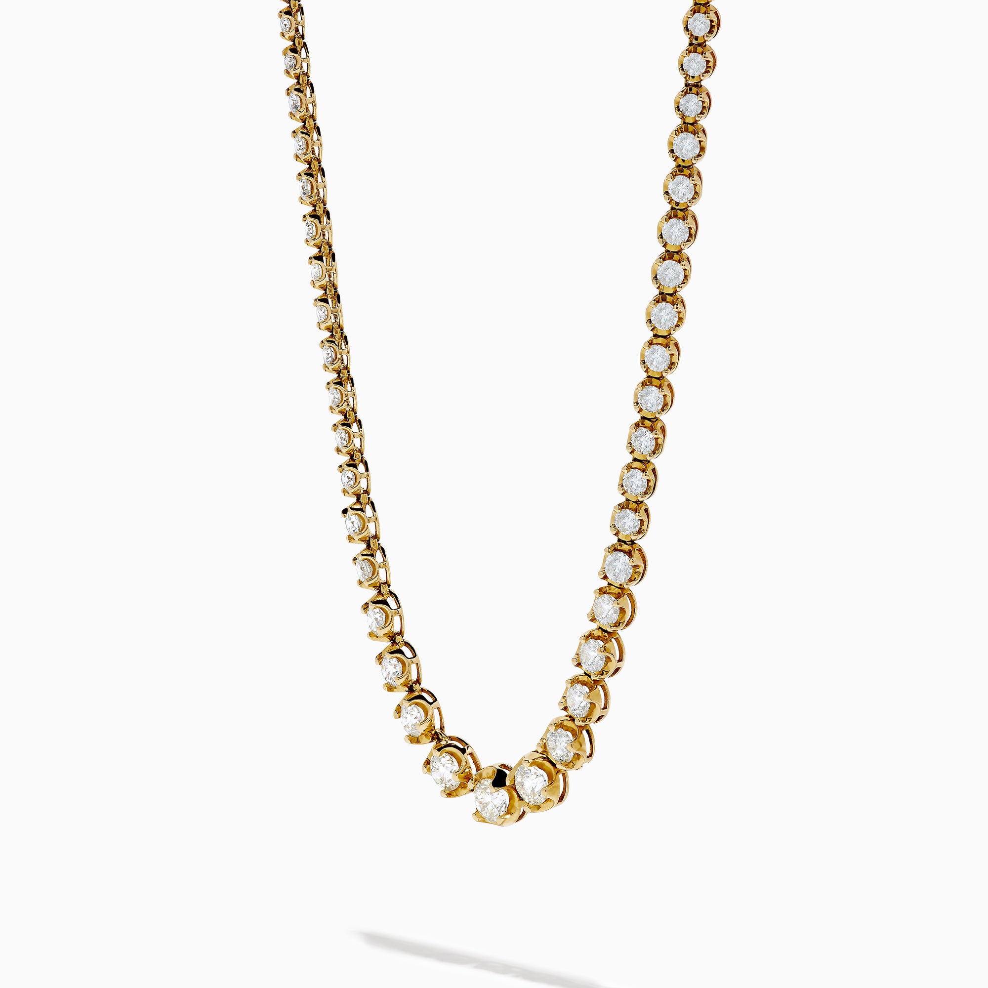 The 14K Yellow Gold Miracle Set Diamond Graduated Tennis Necklace showcases a single row of closely set, sparkling round diamonds in a gentle curve on yellow gold.