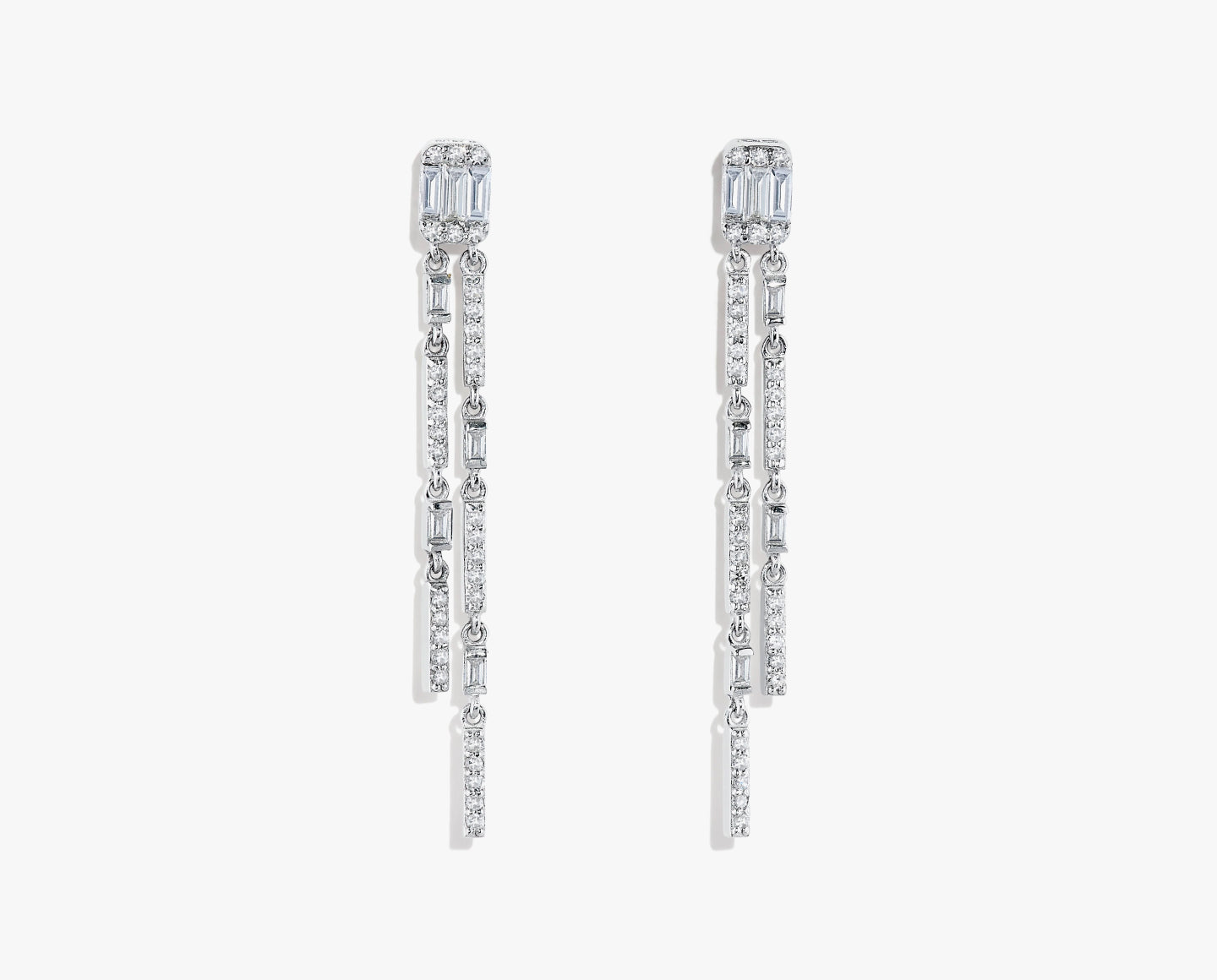 A pair of long, elegant drop earrings featuring multiple rows of baguette and round-cut white gemstones set in a sleek, silver metal.